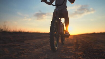 Happy childhood moments, little boy riding bicycle, closeup view of front wheel. Sport activity and children games in weekend or vacation in summertime, ride bike in nature, spinning pedals, details