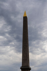 Paris, historical architecture of the city. Egyptian spire on the city square. Paris France.