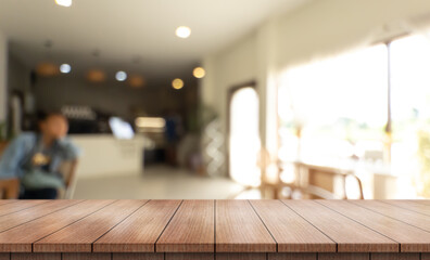 	
Empty wooden table top with lights bokeh on blur restaurant background.