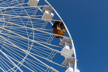 Ferris wheel, attraction with golden VIP cabin. Viareggio, Italy