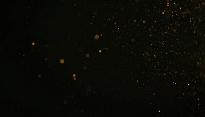 Numerous small, golden particles are scattered and blurred against a dark background.