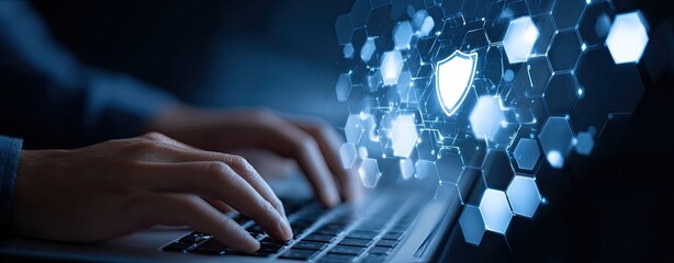 Hands typing on a laptop, security shield graphic overlay