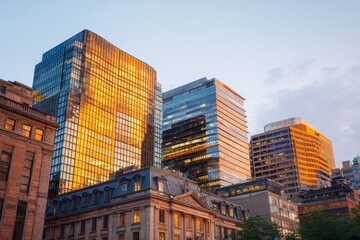 Fototapeta premium Urban Skyline at Sunset with Beautiful Reflections on Buildings
