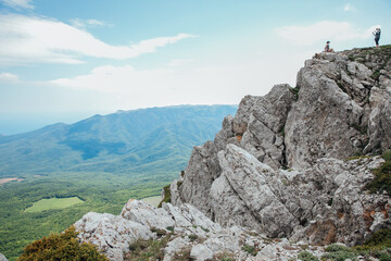 Tourists look at the landscape, mountains and forest