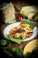 Som Tam , a popular and favourite Thai food dish made of young sliced papaya, chili, tomatoes, palm sugar and dried shrimp.