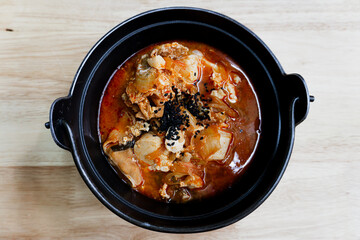 Delicious Korean gourmet hot pot tofu with meat and kimchi soup in a bowl