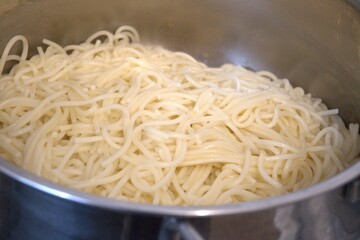 Close-up of freshly boiled spaghetti pasta in a cooking pot. Homemade meal preparation concept.