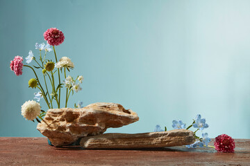A rustic wood base with soft floral arranged against a pastel blue backdrop, designed for natural-themed product presentation.