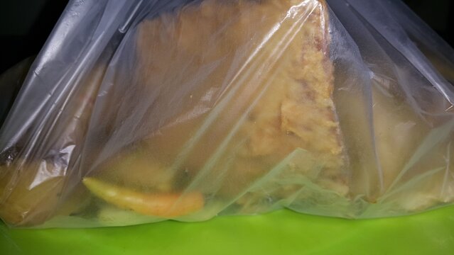 Shot of fried food still in plastic bag.