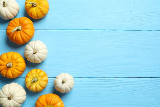 Top view of autumn composition with pumpkins on a white wooden background, top view. Harvest Festival, Thanksgiving and Halloween concept - Powered by Adobe