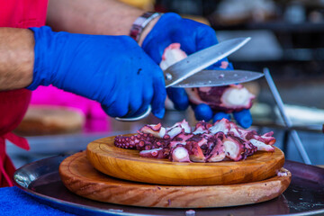 Preparing octopus with olive oil, salt, and paprika