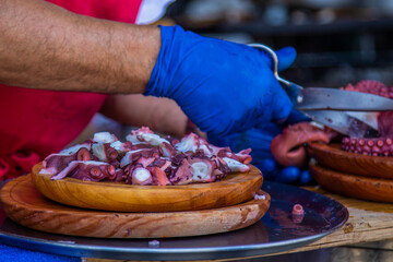 Preparing octopus with olive oil, salt, and paprika