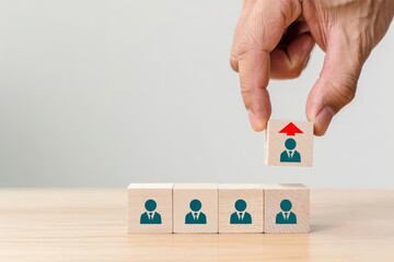 Employee promotion concept hand selecting wooden block with person and arrow up symbol