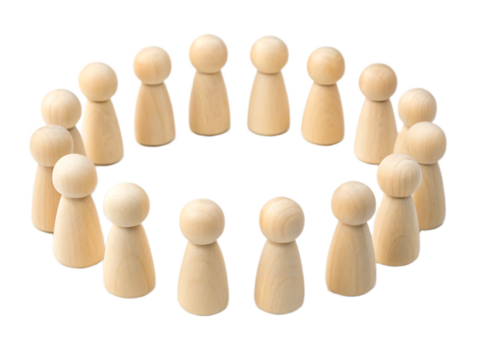 A circle of wooden peg dolls standing on a white surface in a close up studio shot arrangement