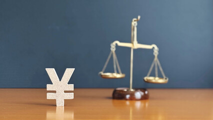 立体の日本円マークと天秤_黒背景