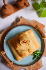  fried spring roll on a plate, topview