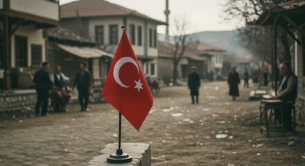 Fototapeta premium Turkish Flag Displayed: A striking image capturing the vibrant Turkish flag proudly displayed against the backdrop of a historic Turkish town, with architecture and the community.