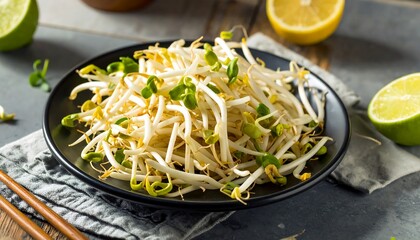 Fresh Sprouted Bean Sprouts on a Black Plate with Lemon and Lime.