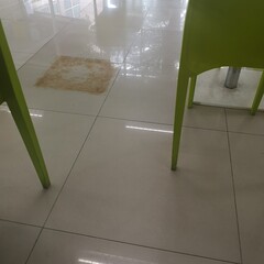 interior of a modern kitchen, Traces and rust stains from the iron table legs that damage the tile surface