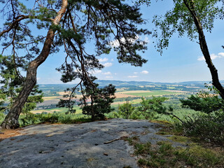 Scenic view from Kalv&aacute;rie lookout in Bohemian Paradise, Czech Republic, overlooking Koz&aacute;kov hill and the picturesque Czech countryside, featuring forests, meadows, and charming rural landscape