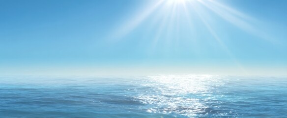 Obraz premium The serene ocean under a bright blue sky and radiant sunlight.