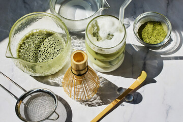 Matcha Preparation. Overhead view of matcha tools with frothy matcha drink