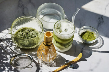 Matcha Preparation. Overhead view of matcha tools with frothy matcha drink