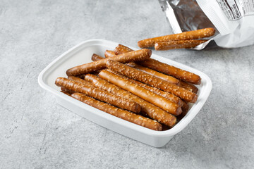 A view of a container of gluten-free pretzel rods.