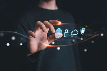 Person touching digital fingerprint security icons on dark background