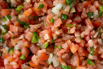 A top down view of a pile of pico de gallo salsa, as a background.