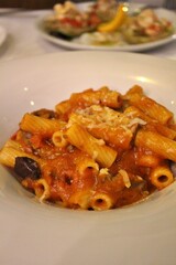 Italian cuisine: rigatoni with beef strips and tomato sauce in Venice, Italy