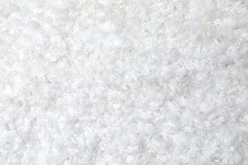 Top view of white cuddle teddy bear fabric texture, close up view