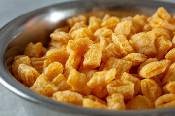 A closeup view of a bowl of popular crunchy cereal.
