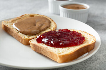 A closeup view of an open face almond butter and jelly gluten-free sandwich.