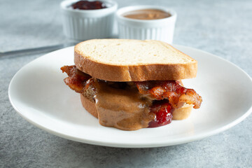 A view of an almond butter, jelly, and bacon gluten-free sandwich.