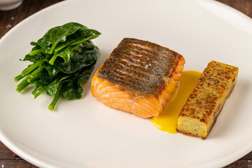 Seared salmon fillet served with wilted spinach and potato croquette