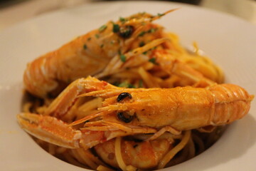 Italian cuisine: spaghetti alla busara (spaghetti with scampi and tomato sauce) in Venice, Italy
