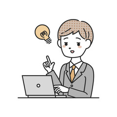 パソコンの前でひらめくスーツを着た男性