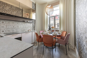 Modern Kitchen Dining Area with Velvet Chairs and Pendant Light