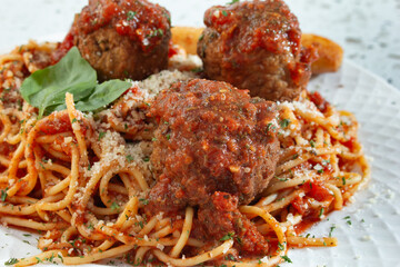 A closeup view of a plate of spaghetti and meatballs.