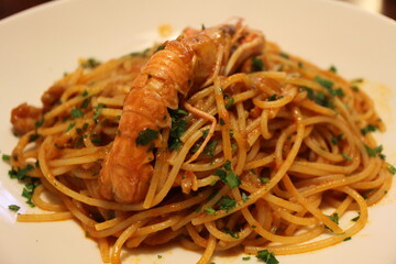 Italian cuisine: spaghetti alla busara (spaghetti with scampi and tomato sauce) in Venice, Italy