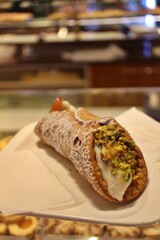Italian dessert: Sicilian cannoli topped with pistachio in Venice, Italy
