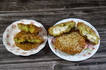 Fried Egyptian falafel balls, green burger, made of ground chickpeas and broad beans, deep fried balls or patty-shaped fritter stuffed with Creamy Cheese Spread, falafel filled with cheese and plain