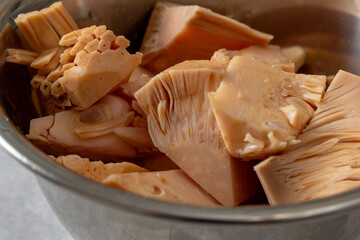 A closeup view of a metal bowl of canned young jackfruit.