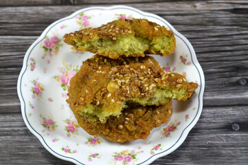 Egyptian fried falafel balls, green burger, made of ground chickpeas and broad beans, deep fried balls or patty-shaped fritter, with sesame, fried in deep oil and topped with sesame seeds