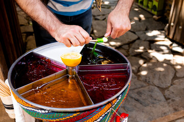 Traditional middle eastern sweets vendor stirring vibrant caramel