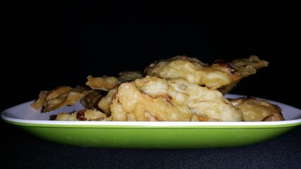 Close up shot of bakwan. Bakwan is a vegetable fritter or fried food that is commonly found in Indonesia. The ingredients use vegetables; bean sprouts, shredded cabbage and carrots, coated in batter.