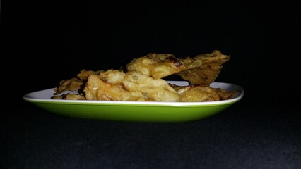 Close up shot of bakwan. Bakwan is a vegetable fritter or fried food that is commonly found in Indonesia. The ingredients use vegetables; bean sprouts, shredded cabbage and carrots, coated in batter.