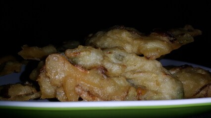 Close up shot of bakwan. Bakwan is a vegetable fritter or fried food that is commonly found in Indonesia. The ingredients use vegetables; bean sprouts, shredded cabbage and carrots, coated in batter.