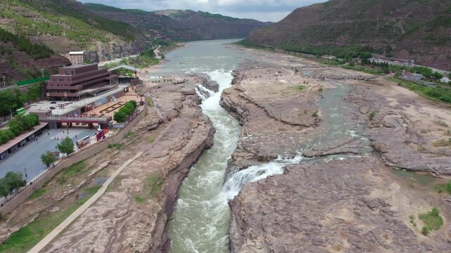 Drone view of Hukou Waterfall in Shanxi Province, China, it is a magnificent sight of the surging Yellow River water, filled with energy and awe inspiring，4k real time footage aerial view.